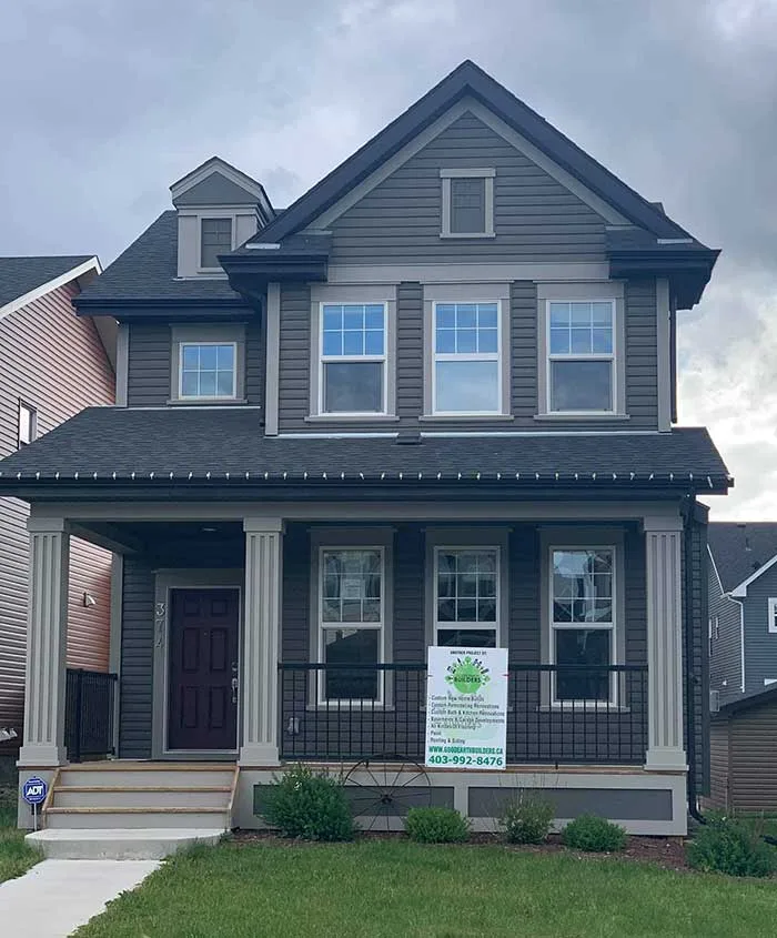 Energy-efficient home with solar panels designed by Good Earth Builders.
